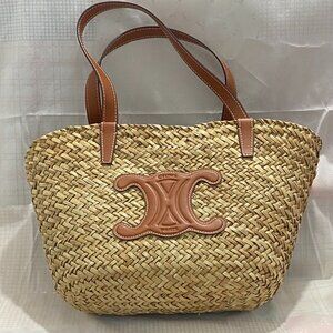Celine's Classic Straw Tote Features Brown Leather Handles And A Heart-Shaped Lo